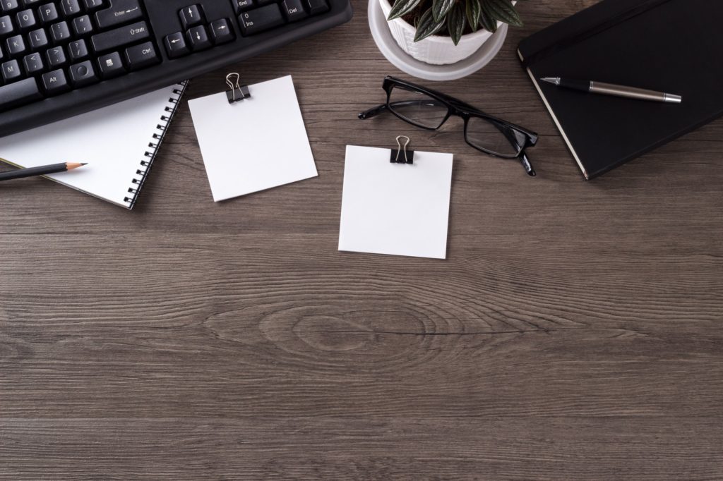 Desk with computer keyboard and notepad